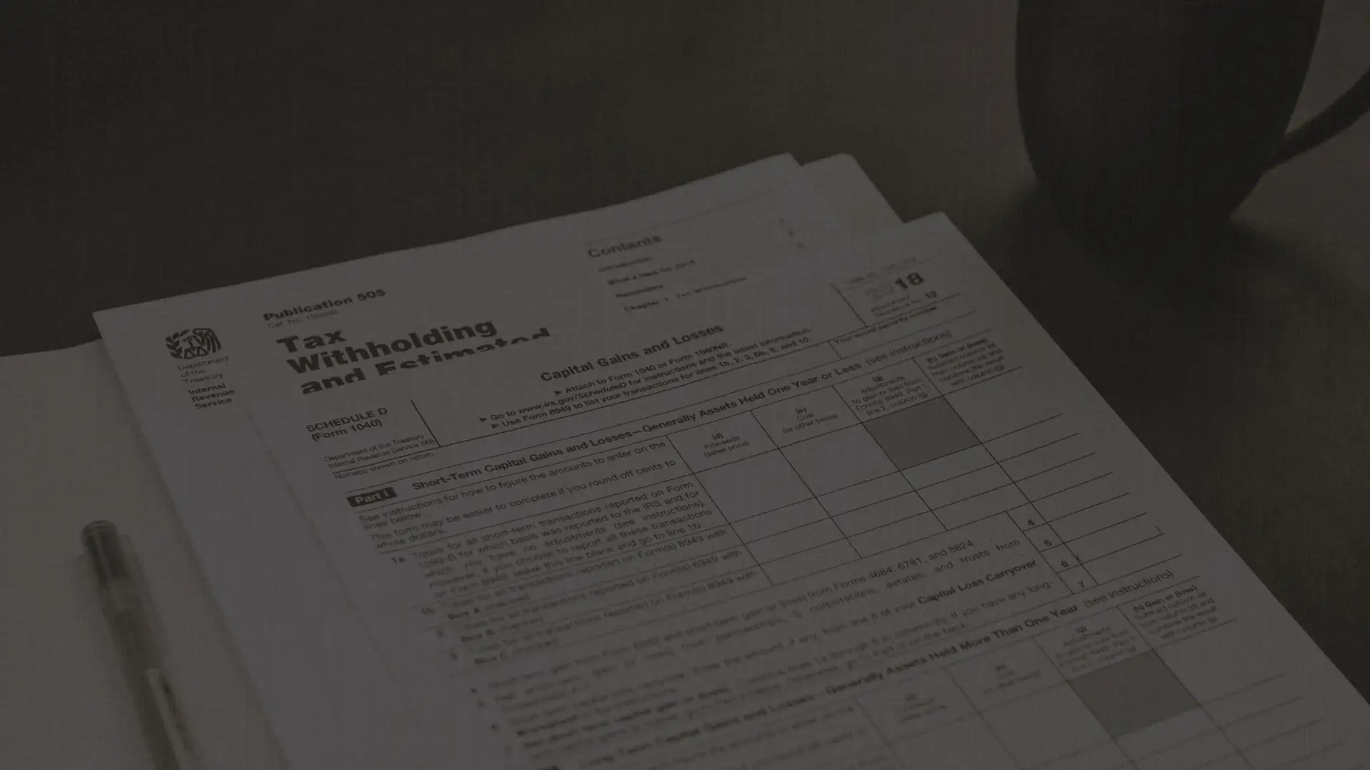 Documents and a pen on a desk